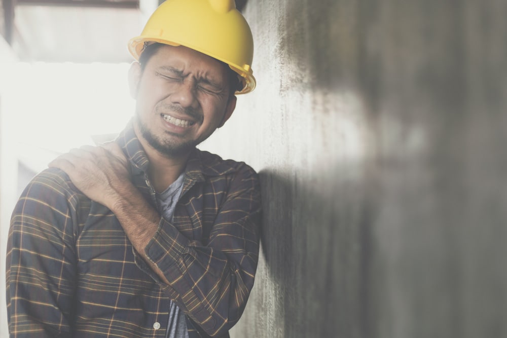 Man Holding His Shoulder In Pain