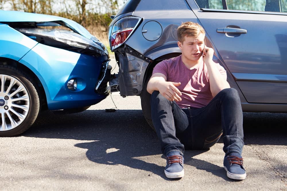 Man Talking On The Phone Next Two A Car Crash