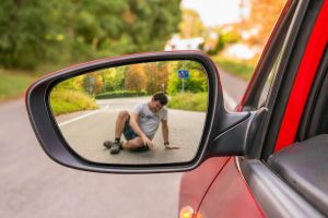 Injured Pedestrian In The Side Mirror Of A Car