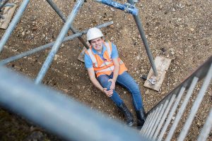 Construction Worker Sitting On The Ground In Pain