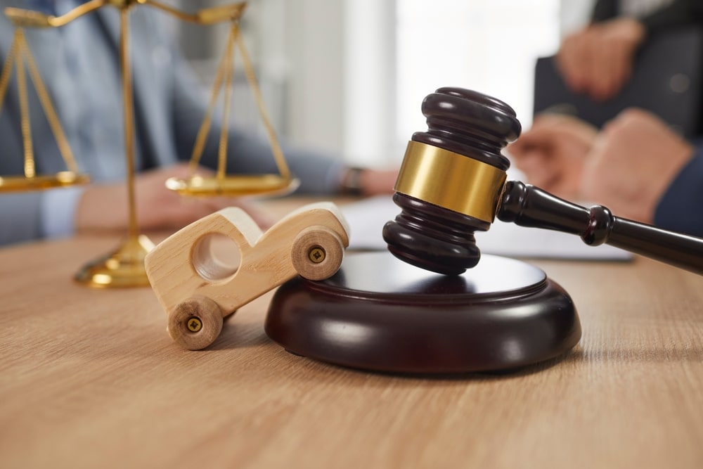 Judges Hammer And A Wooden Toy Car On The Table