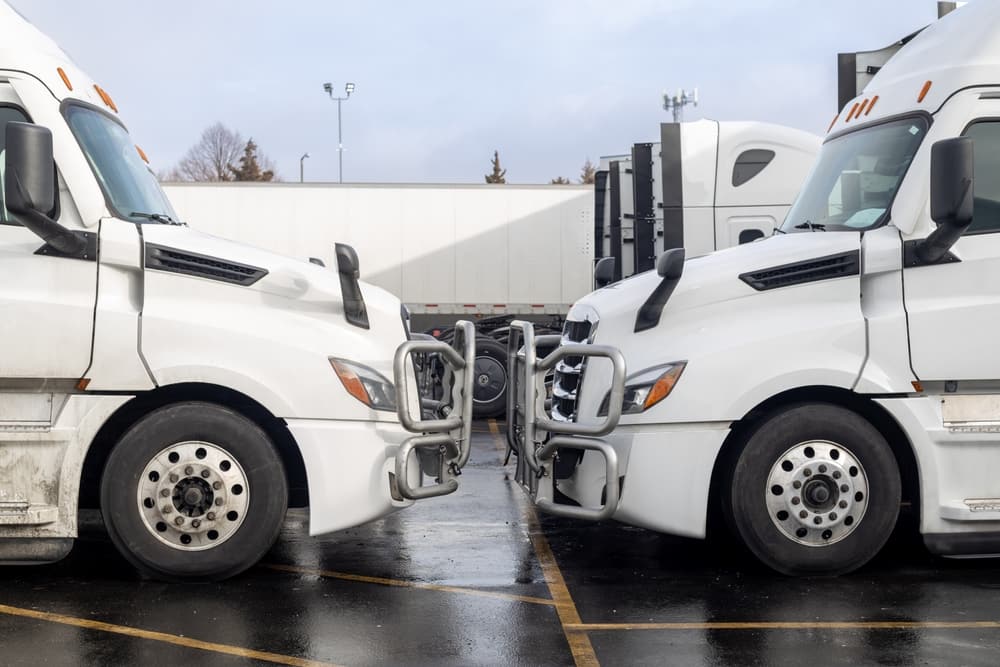 Two White Trucks Facing Each Other