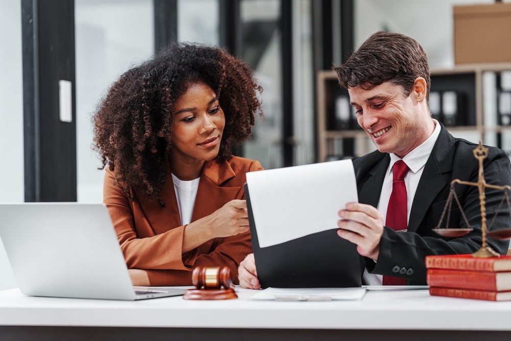 Lawyer And His Client Looking At Documents