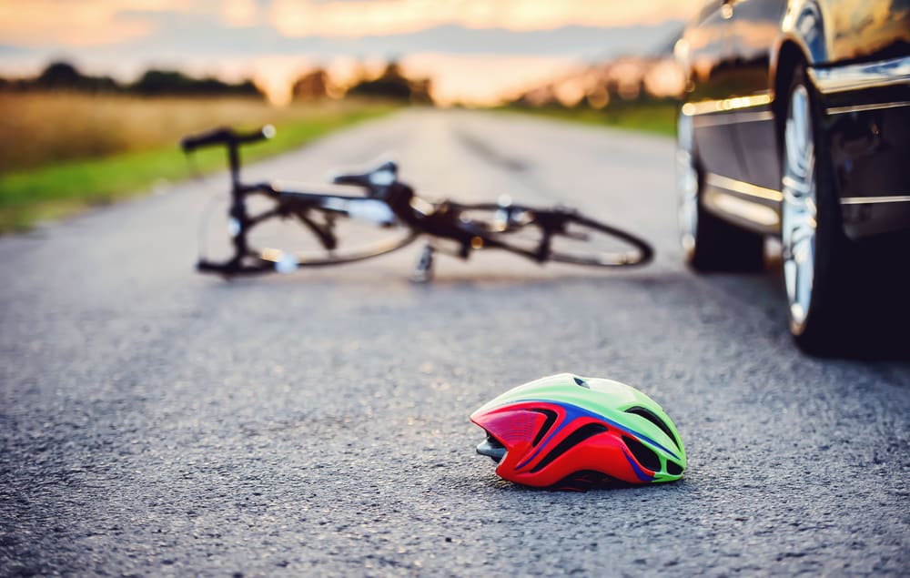 Bicycle Helmet And A Bicycle Laying On The Road