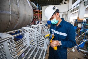 Construction Worker Looking At A Gas Boiler System